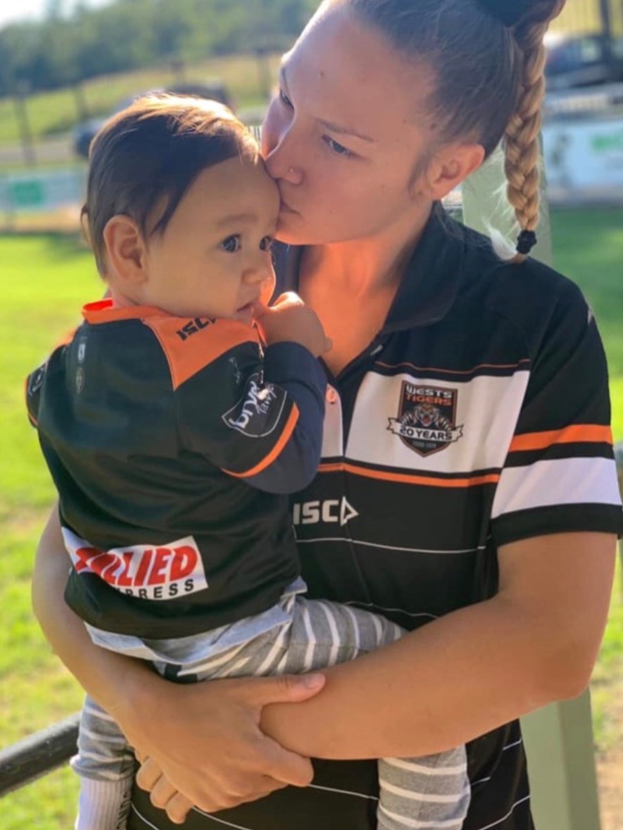 Jessie kissing her son Kylo on the cheek.